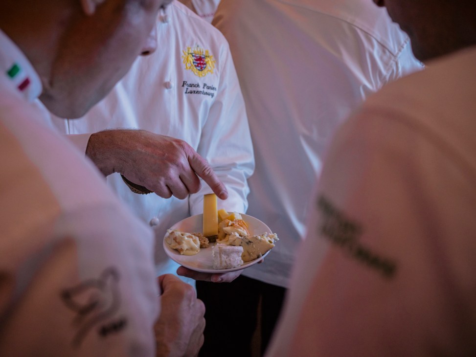 Chefs examining and discussing the catered food