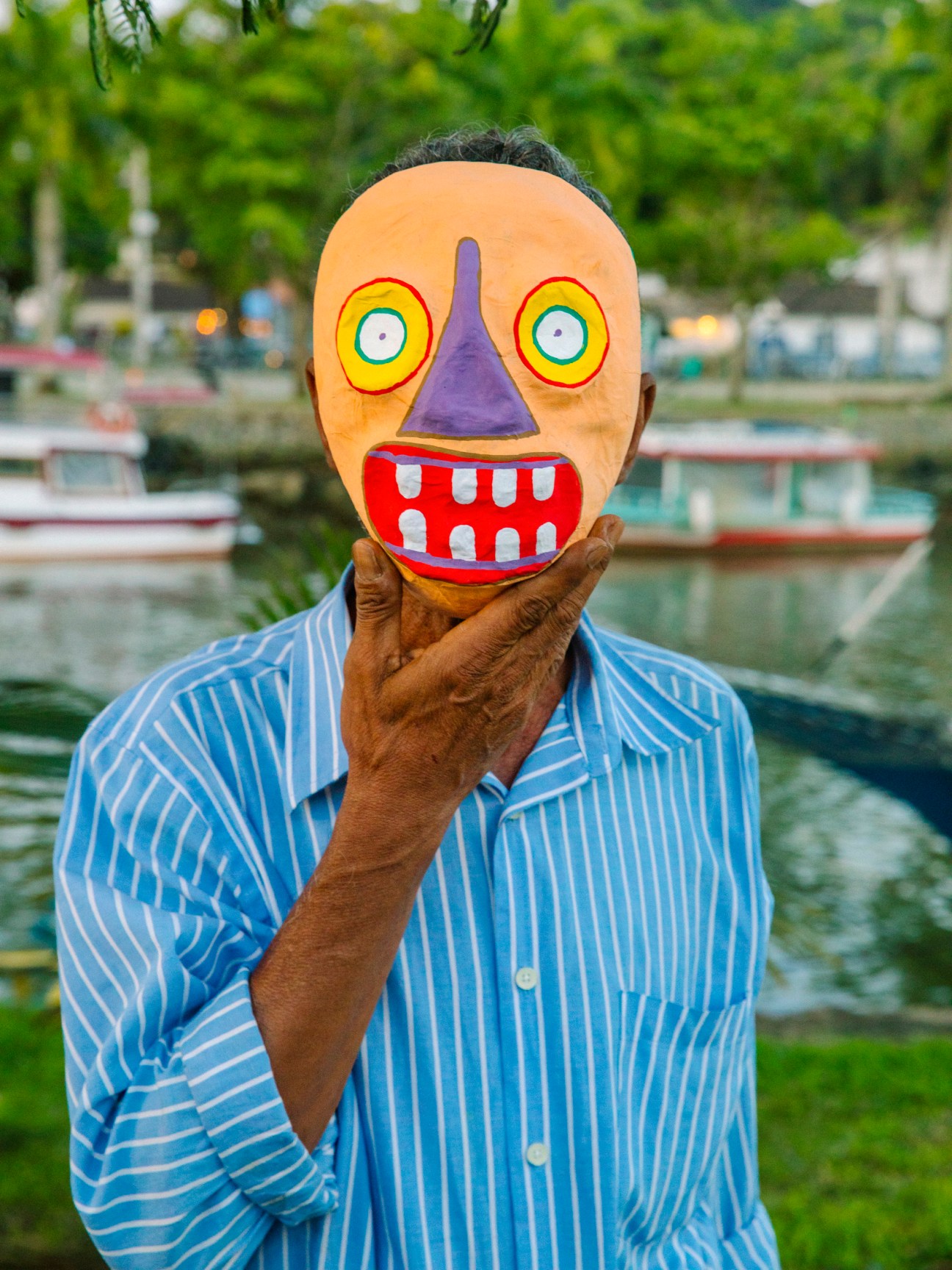 Carlos ‘Noca’ Araújo modelling one of the handmade masks that he sells