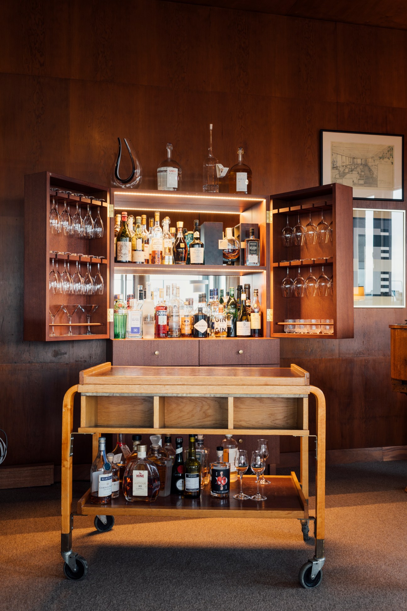 Bentwood birch bar trolley from 1936 at Savoy restaurant in Helsinki with built-in bar cabinet behind