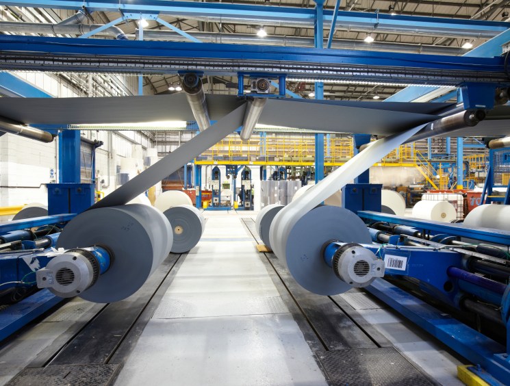 Paper goes through machine that cuts it