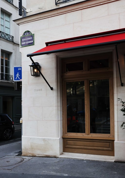 Understated exterior entrance to Cravan bar on Boulevard Saint-Germain with traditional French architecture