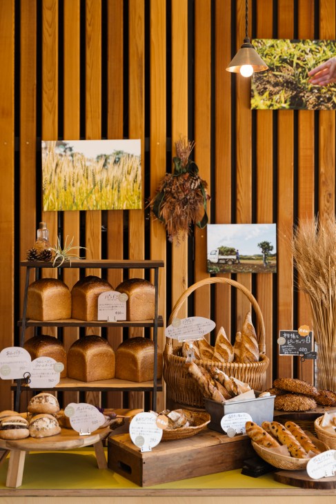 Interior of Lanka bakery showing shelves of fresh bread loaves and baguettes in wicker baskets with price tags