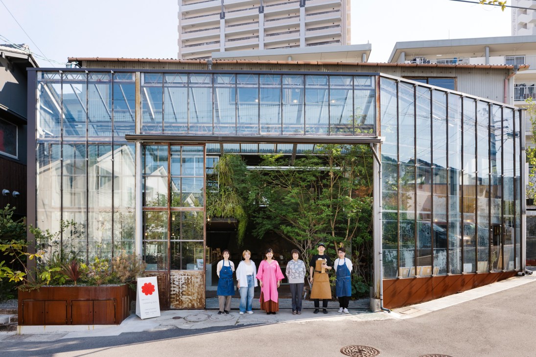 Community members gathering at Minagarten development with outdoor seating and greenery