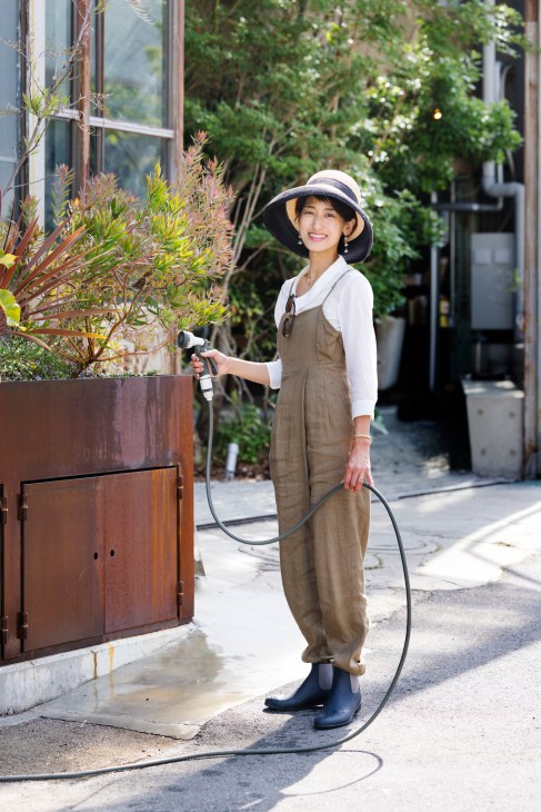 Lan Haguma watering plants in the community garden area