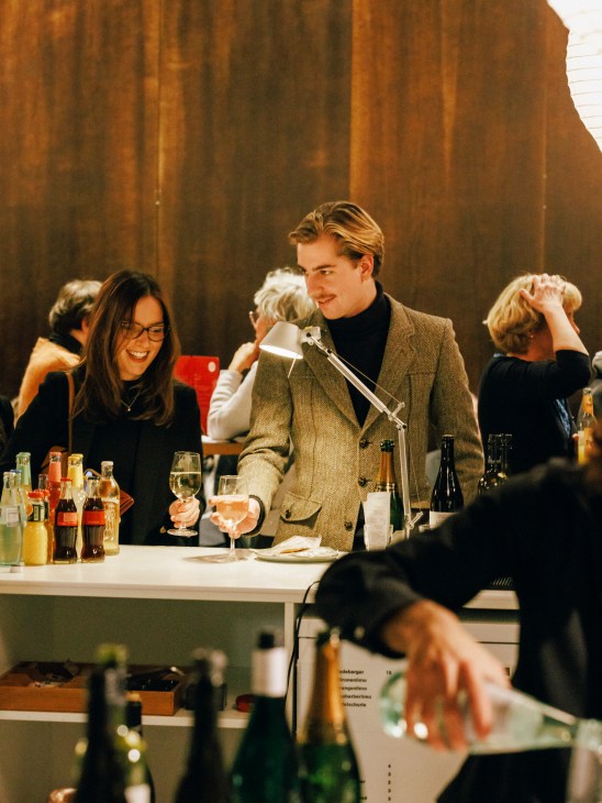 Patrons at the opera house bar ordering refreshments before the show