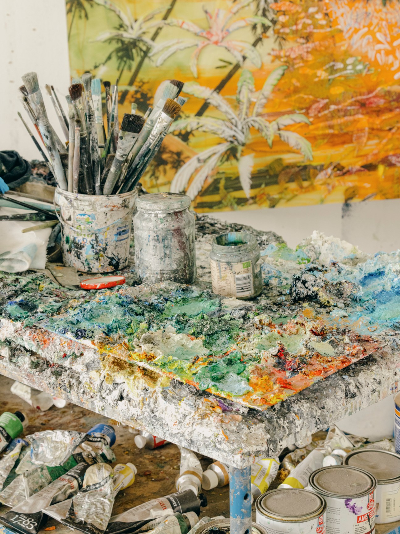 Close-up of colorful paint layers and textures on an artist's palette or work surface