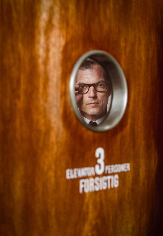 Mikael Bertelsen sitting at his desk reviewing notes