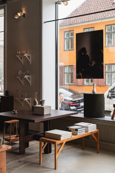 Interior view of Frama's main store on Fredericiagade showing wooden shelves, furniture displays, and large windows