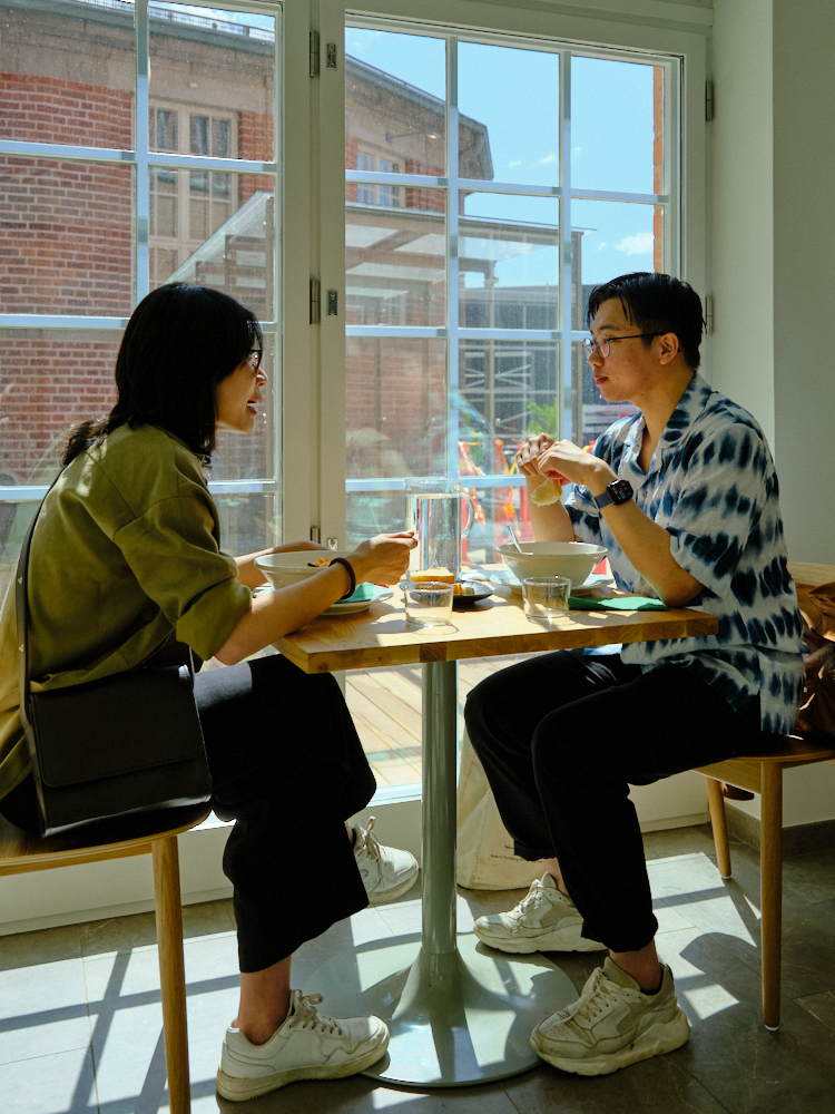 Two people sitting at a table by large windows in Kirsikka restaurant