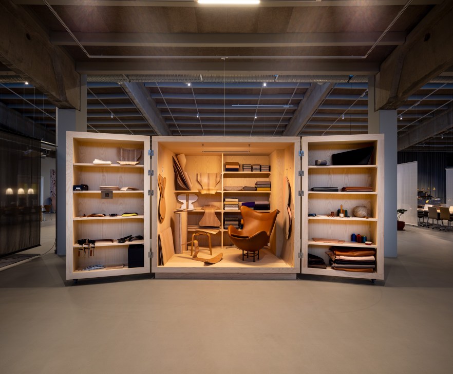 An open wardrobe in a show room showing a small room inside it