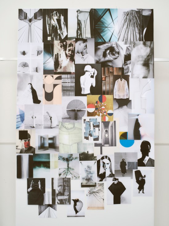 Mood board collage of black and white fashion photographs, architectural elements, and design inspiration pinned to wall