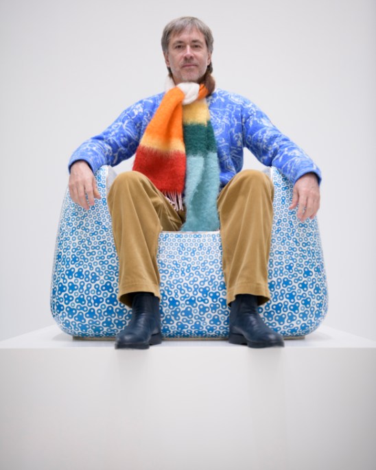 Marc Newson's cloisonné enamelled armchair in blue, featuring petal-like swirls and metalwork patterns, displayed in the Gagosian gallery