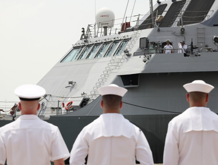US Navy personnel greet the ‘Freedom’ in Singapore