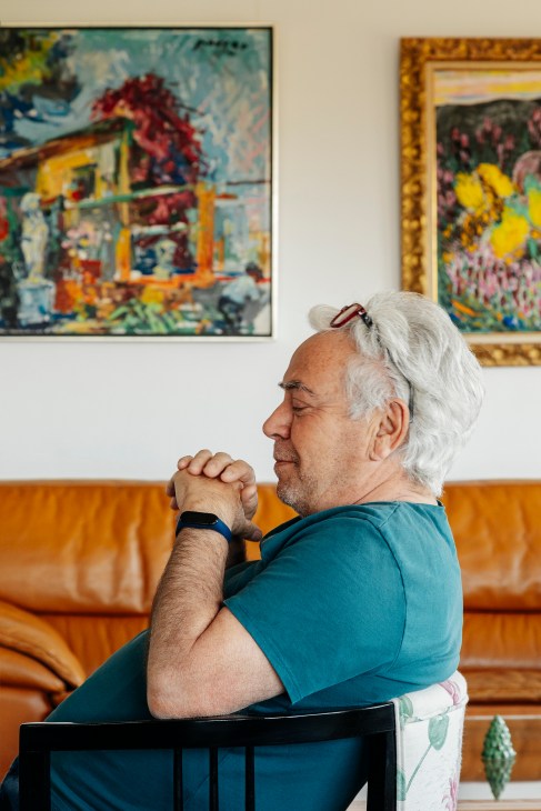 Pepe Cano standing in his apartment overlooking Valencia cityscape