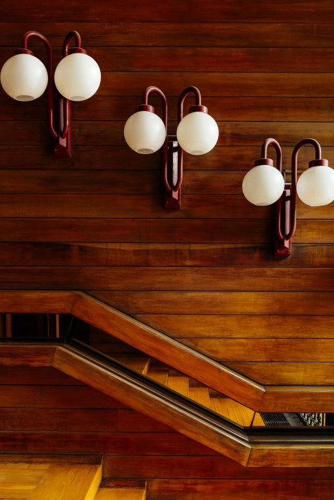 Timber-clad entrance lobby with wooden bannisters and natural materials