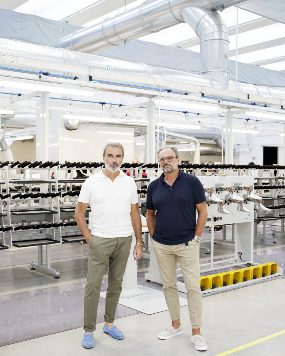 Craftsman working on luxury footwear in Italian shoe factory with tools and materials