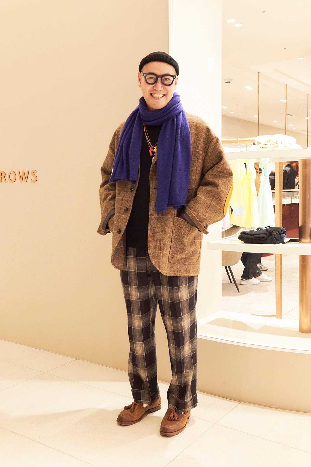 Fashionable individual posing in a retail space at Azabudai Hills