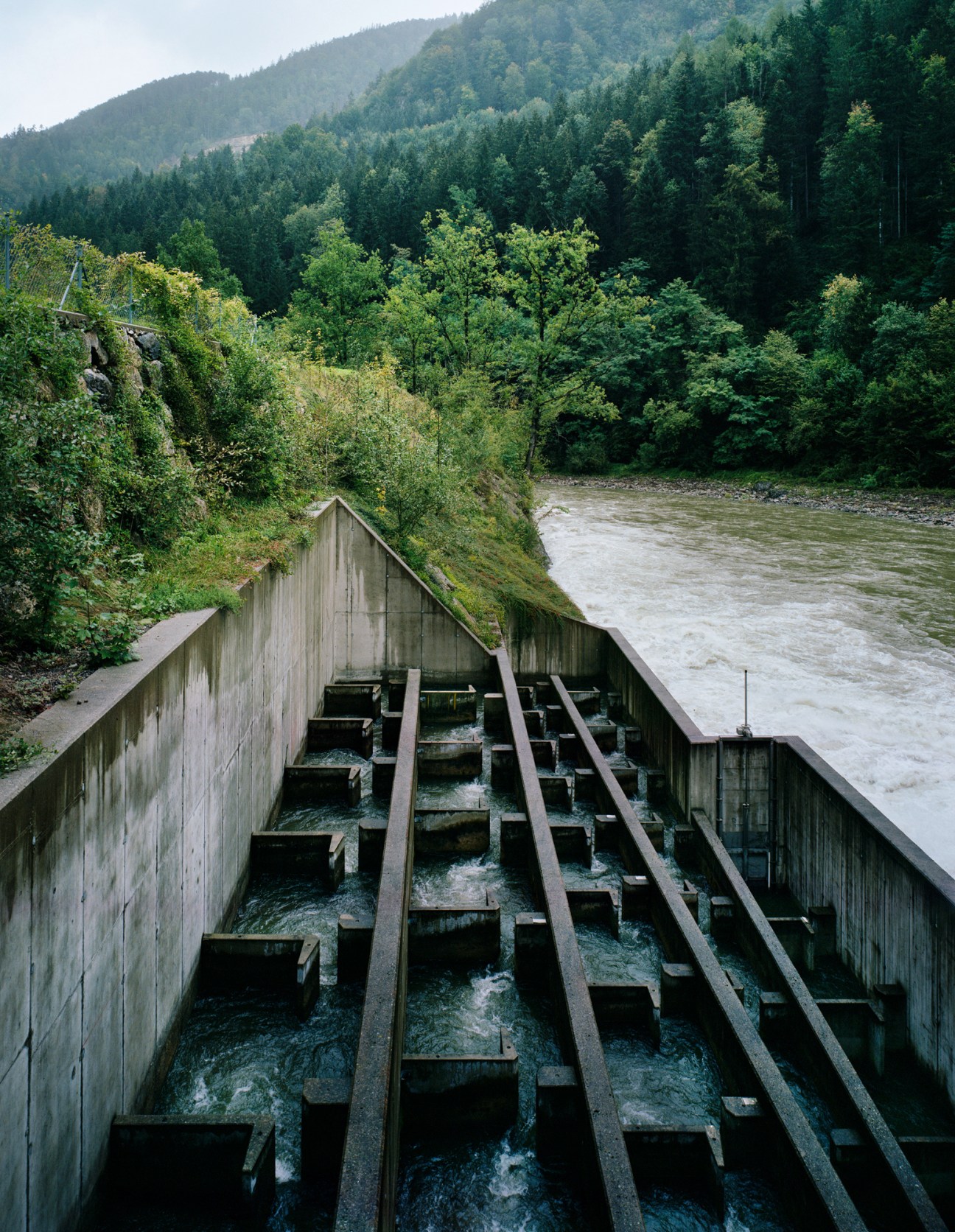 Water rushing through fish ladder or spillway structure with concrete channels