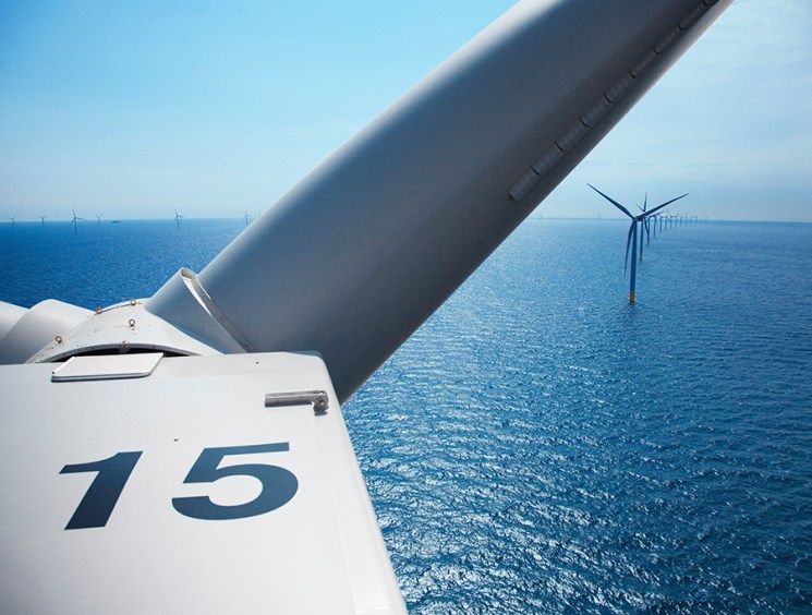 View from inside wind turbine nacelle showing offshore wind farm with number 15 visible on turbine housing