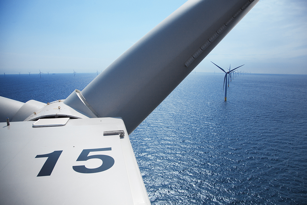 View from inside wind turbine nacelle showing offshore wind farm with number 15 visible on turbine housing