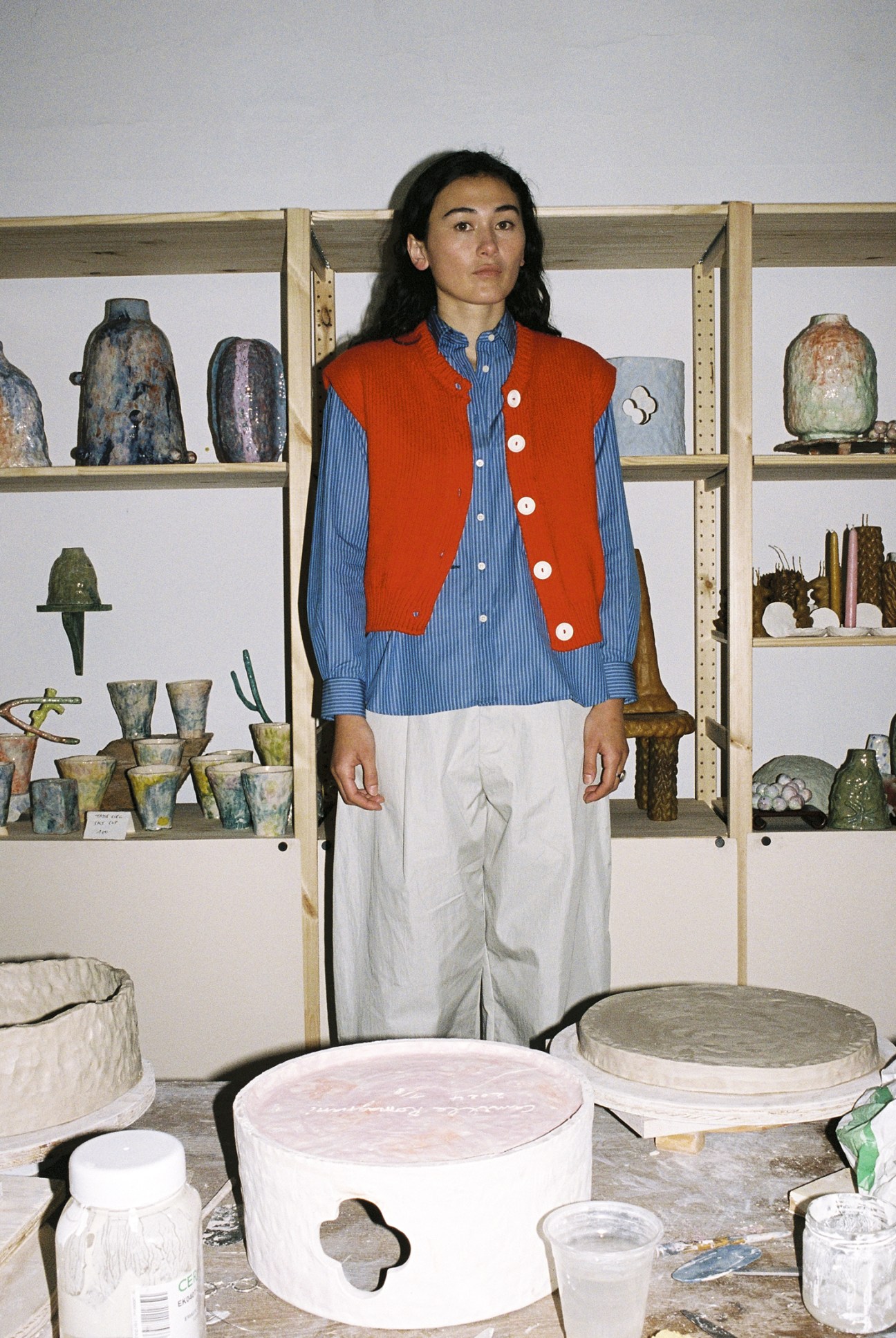 Camille Romagnani wears sleeveless vest by Babaà, shirt by Patine, trousers by Studio Nicholson, ring by Agnès B