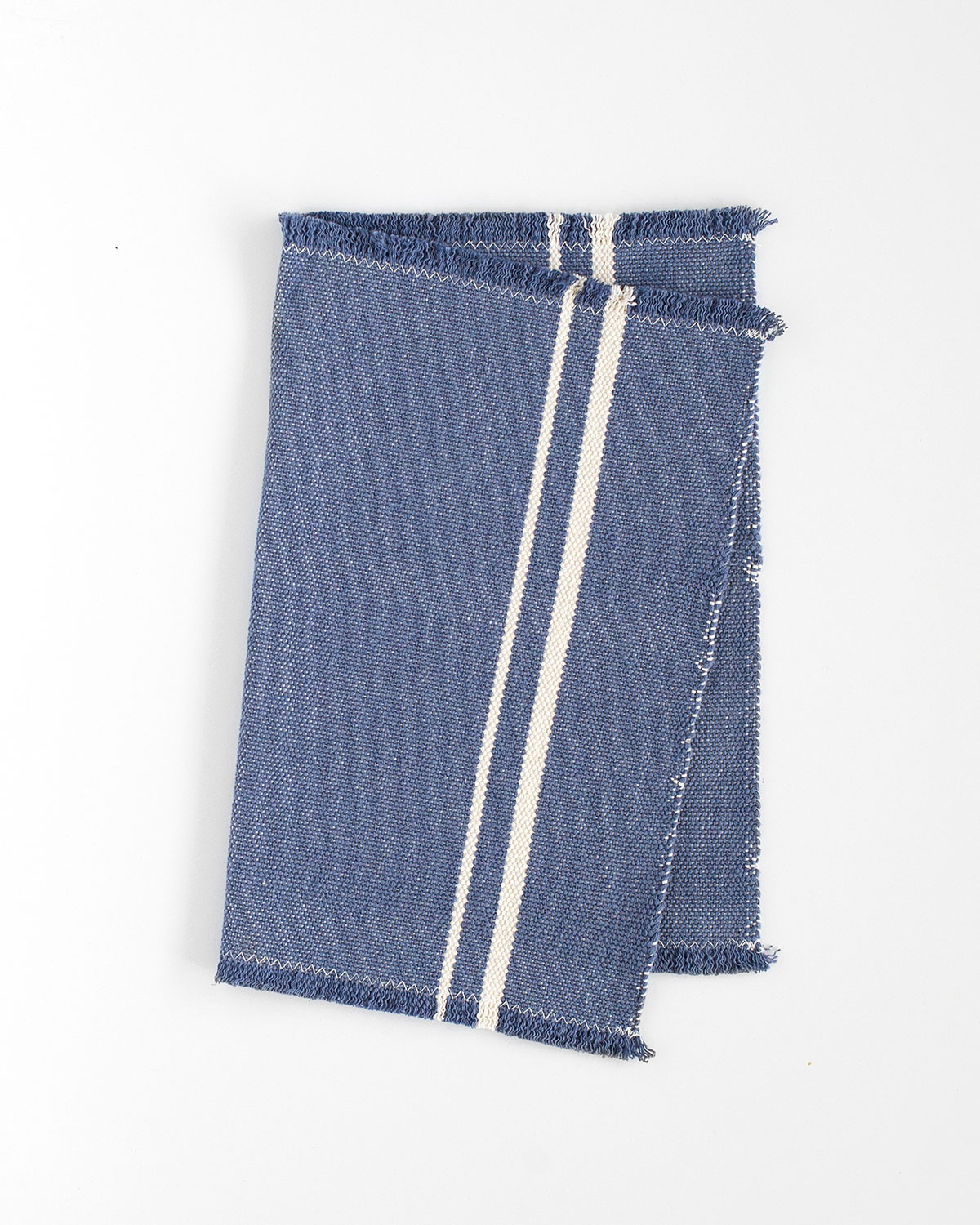 Blue woven textile with white stripes and frayed edges from Barrydale Hand Weavers