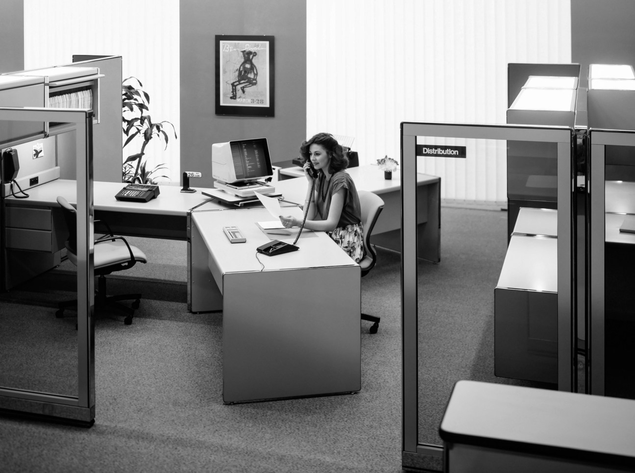 Framery office pod with curved glass walls in modern open-plan workspace