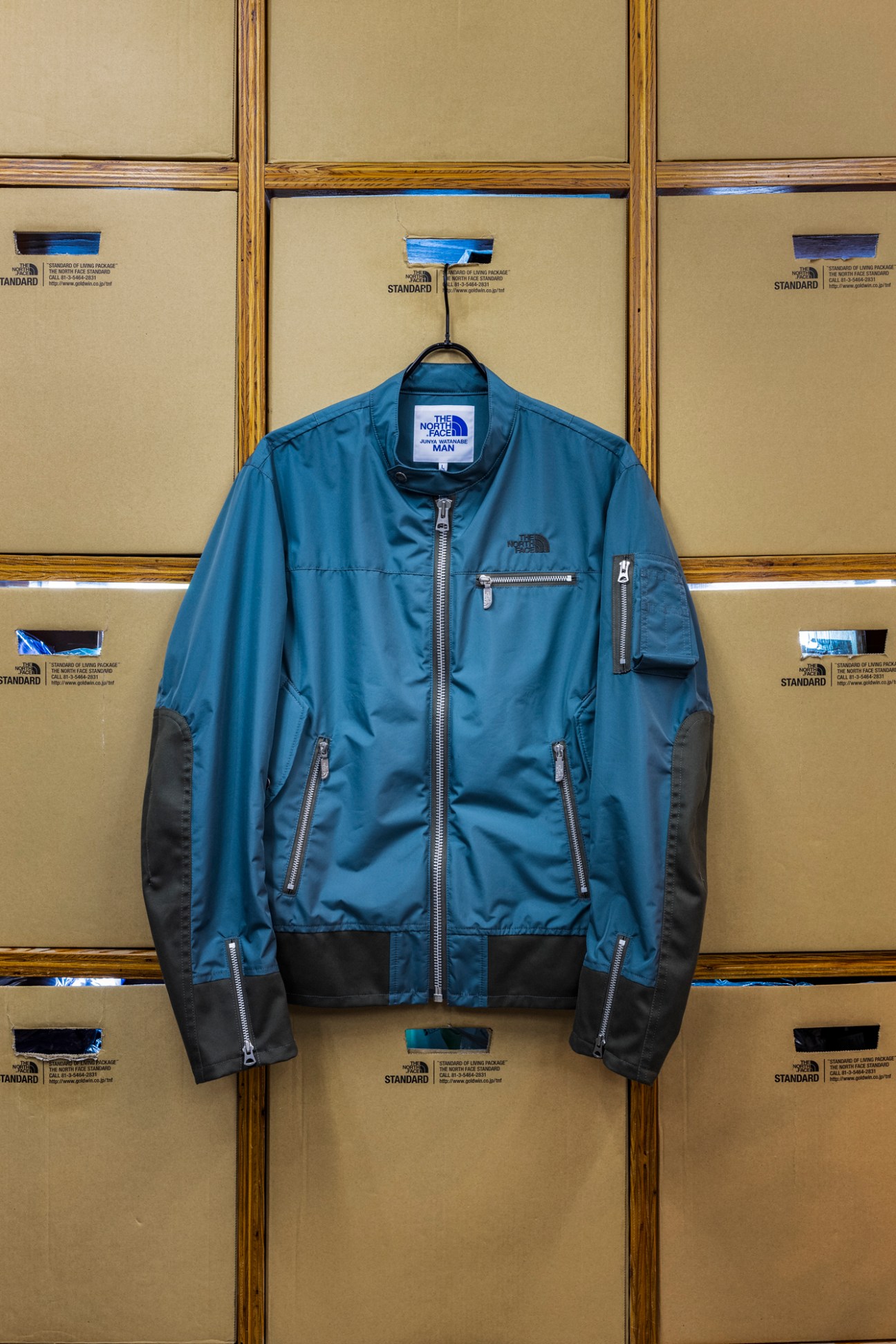 Comme des Garçons Junya Watanabe Man 3 The North Face collaboration jacket displayed on wooden retail fixture