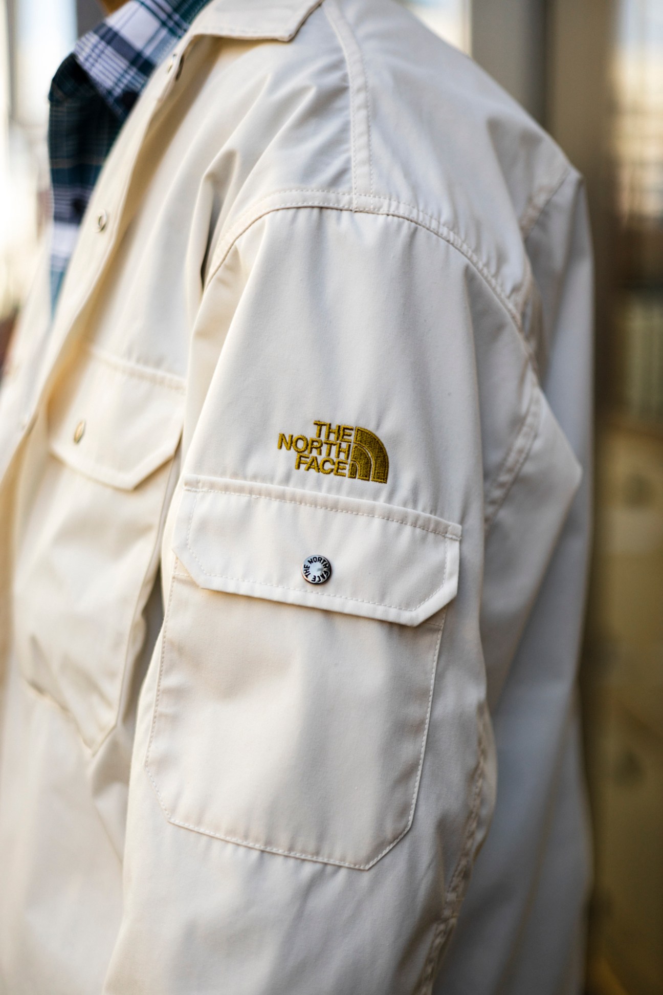 Light colored spring jacket displayed on clothing rack