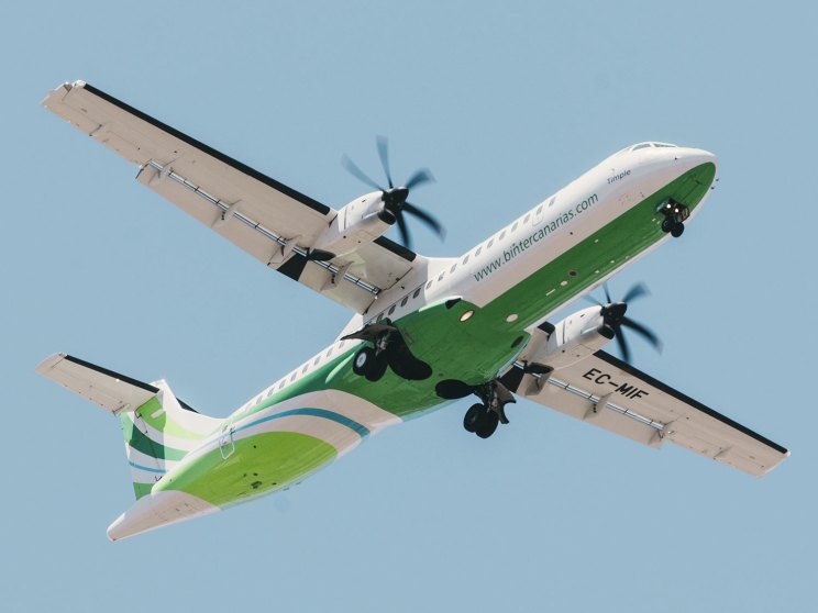 Binter Canarias aircraft in flight against blue sky