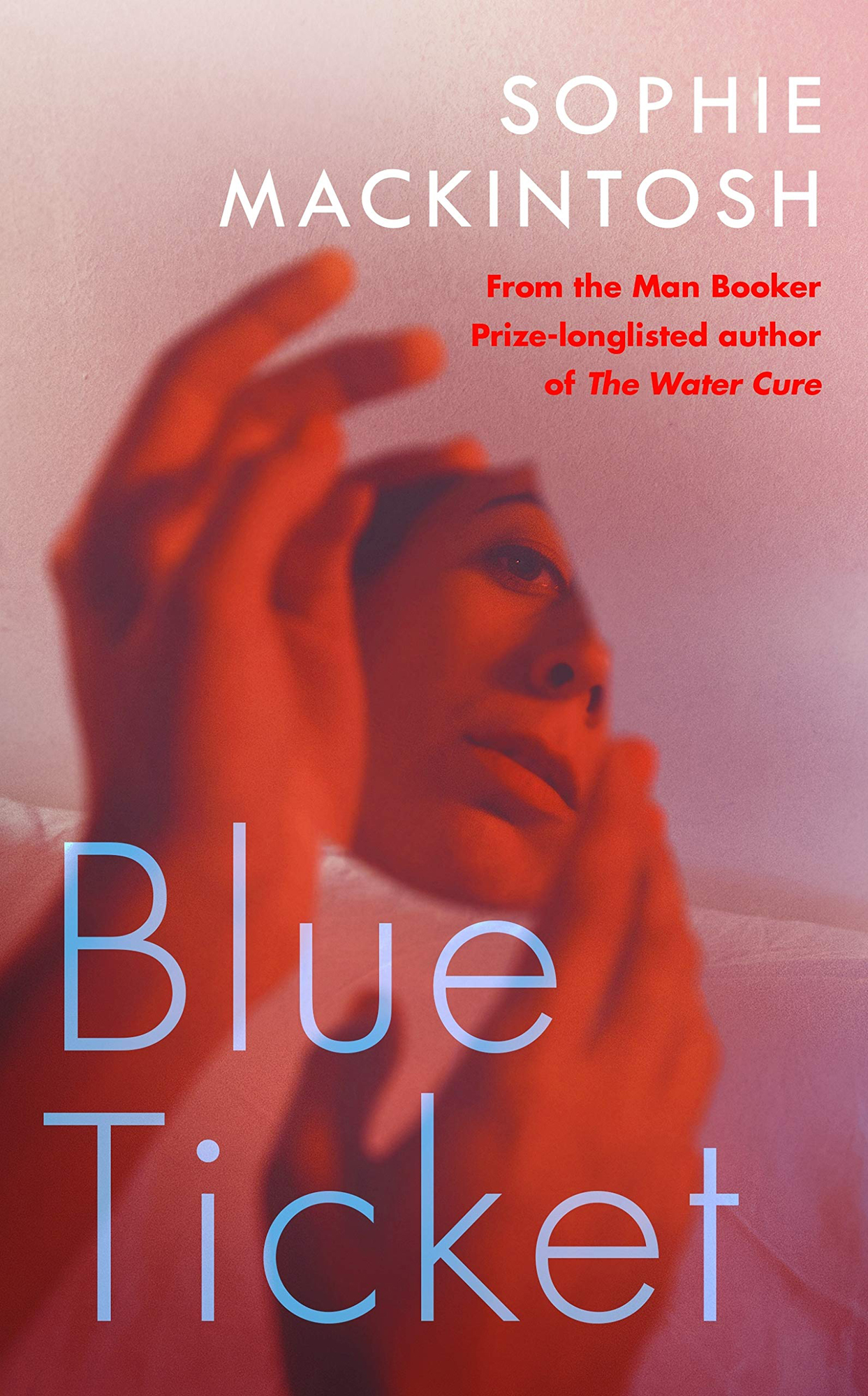 Book cover of Blue Ticket by Sophie Mackintosh showing a woman's face in red and pink tones