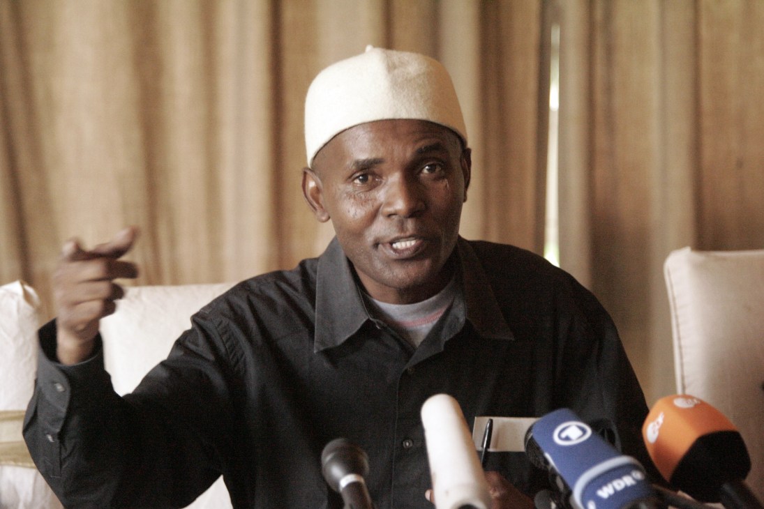Andrew Mwangura speaks at a press conference with microphones in front of him.