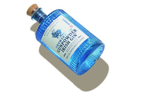 Bottle of Drumshanbo Gunpowder Irish gin with blue label and cork stopper.