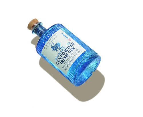 Bottle of Drumshanbo Gunpowder Irish gin with blue label and cork stopper.