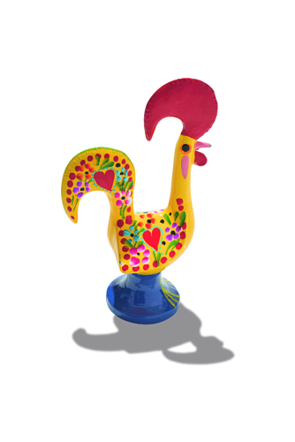 Colorful ceramic rooster figurine with yellow body and red comb, representing the Rooster of Barcelos.