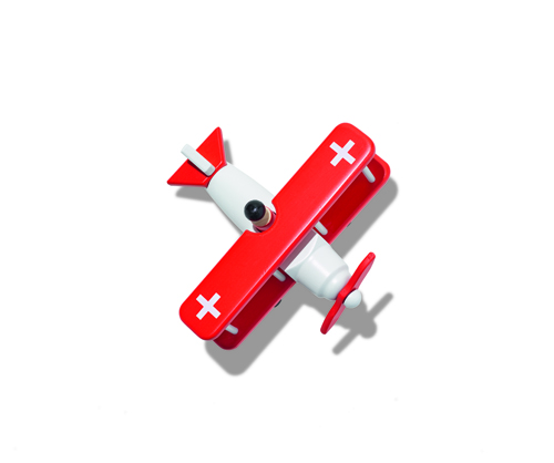 Red and white wooden toy plane with Swiss flag emblem.