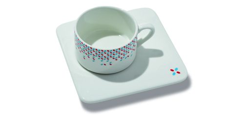 White ceramic teacup and coaster decorated with Luxembourg's flag colours.