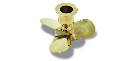 Brass propeller-shaped candlestick with three blades and cylindrical holder on white background