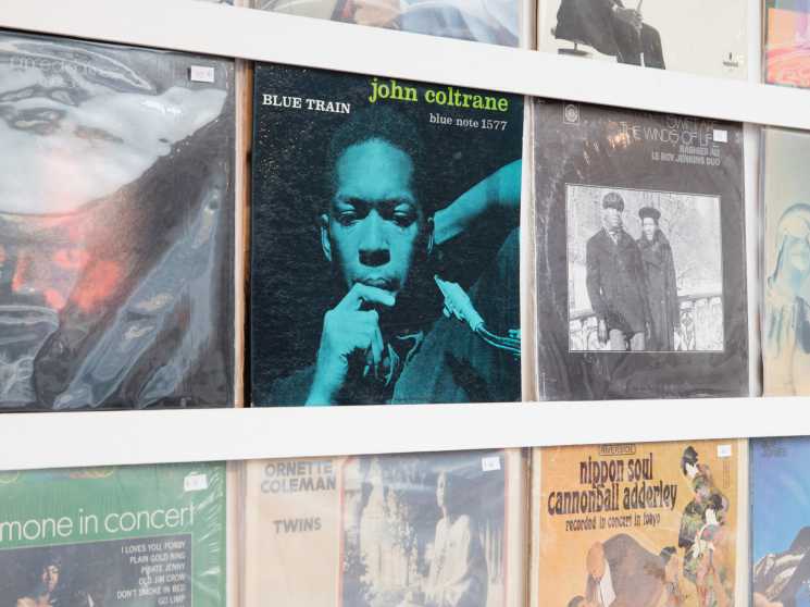 Interior of Cosmos Records showing rows of vinyl records organized in bins