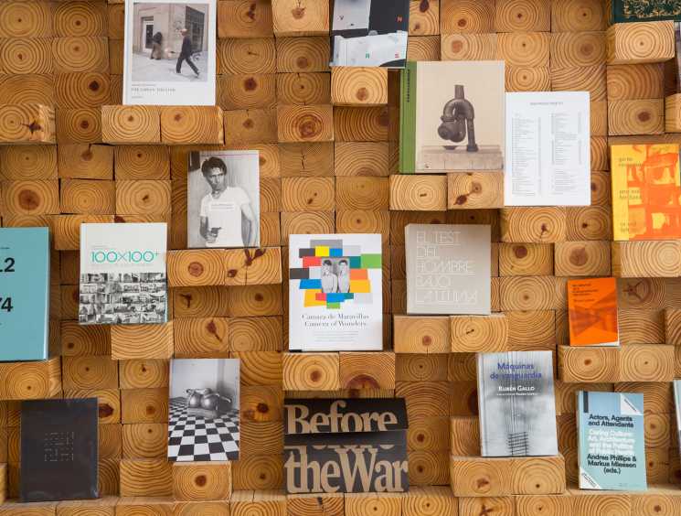 Display of art books and magazines on wooden circular shelving at Casa Bosques shop.