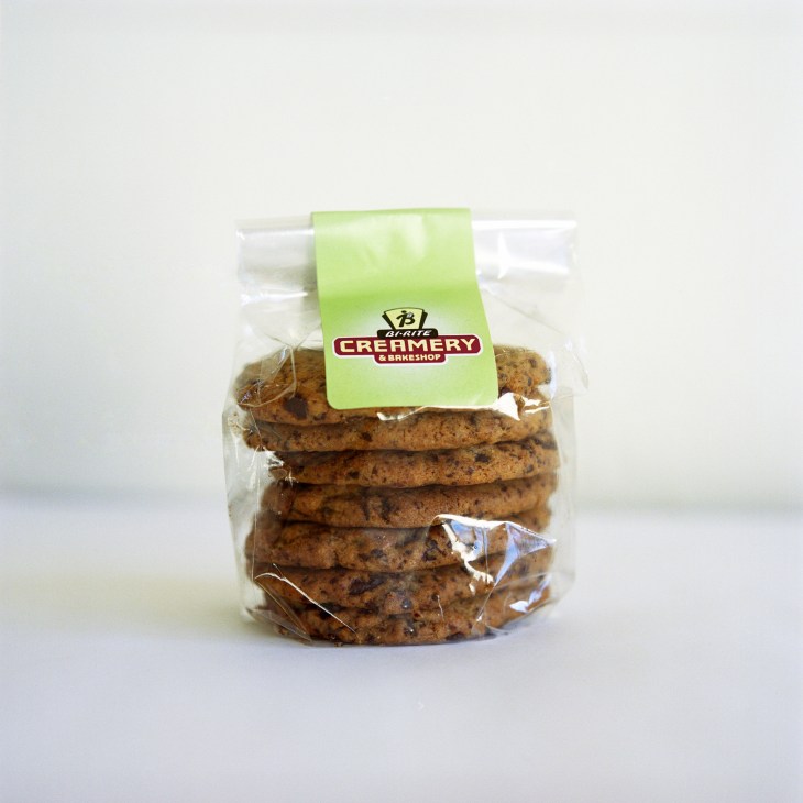 Package of Bi-Rite Creamery chocolate chip cookies with green label against white background.