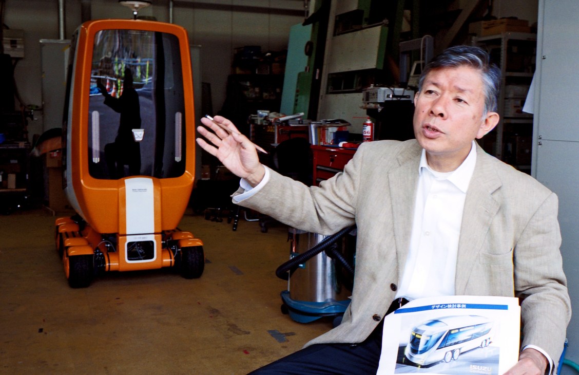 Professor Hiroshi Shimizu presents the Electric Vehicle Laboratory's prototype electric bus at Keio University in Tokyo.