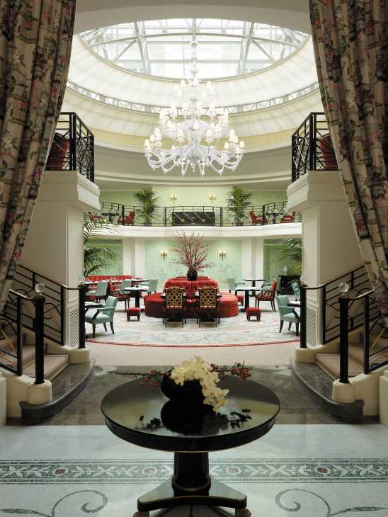 Shangri-La Paris hotel lobby with domed skylight, crystal chandelier, and elegant furnishings.