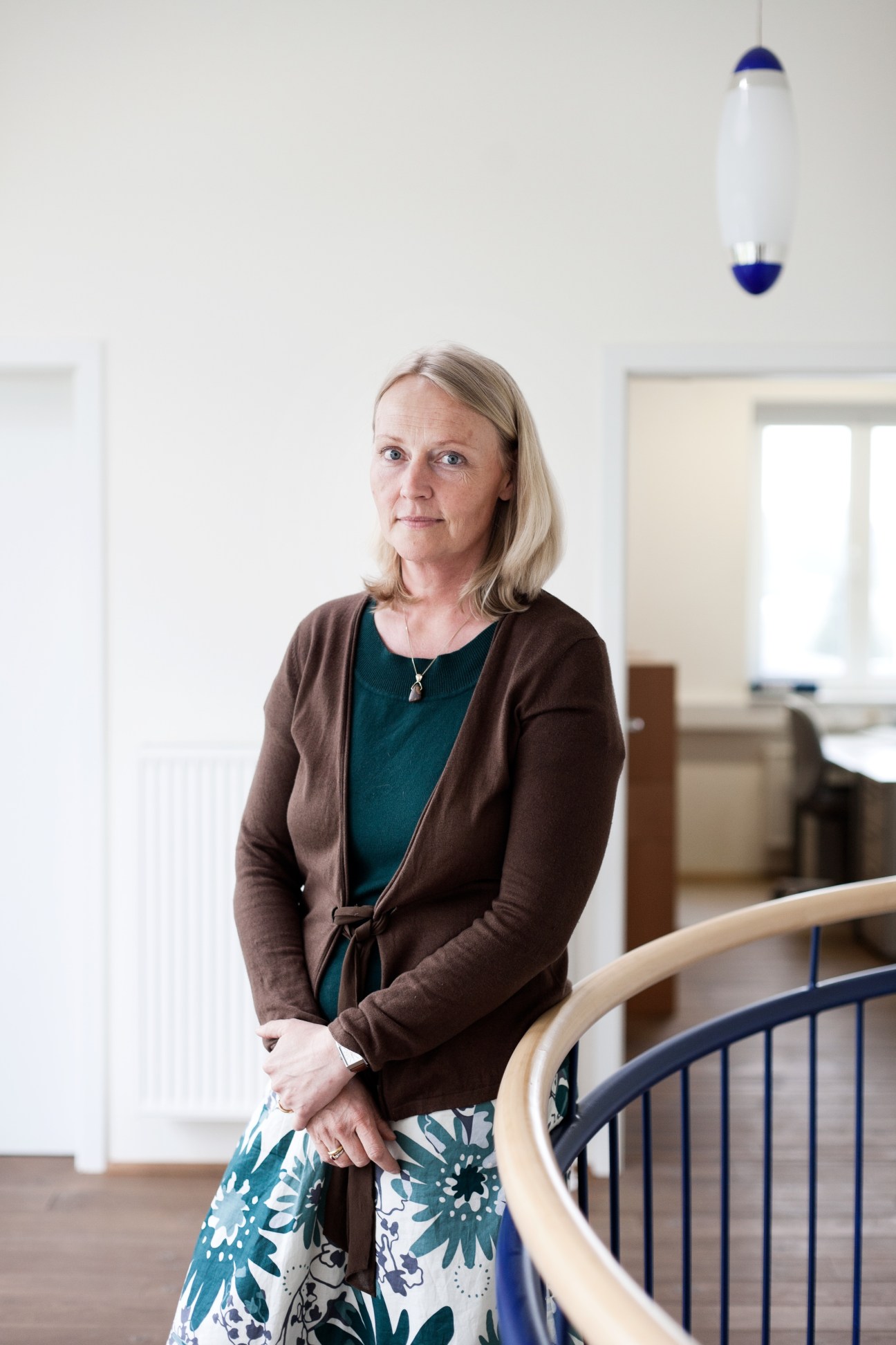 Helena Sundblad-Schäfer, CEO of Spülboy, standing in an office with a white and blue wall clock behind her.