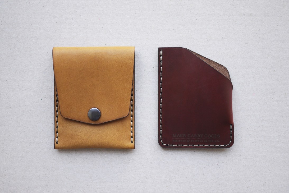 Two leather accessories displayed: a tan leather card case with snap closure and a burgundy leather wallet with white stitching.
