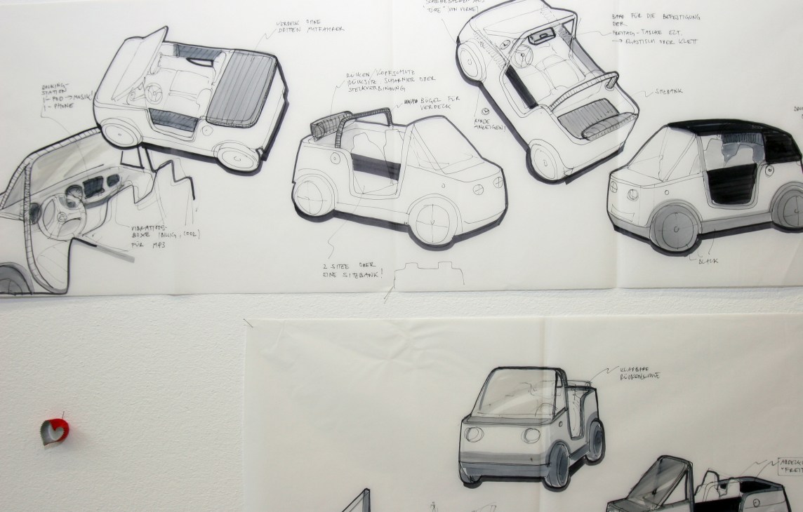 Design sketches of the E'mo electric car with technical annotations and multiple concept views.