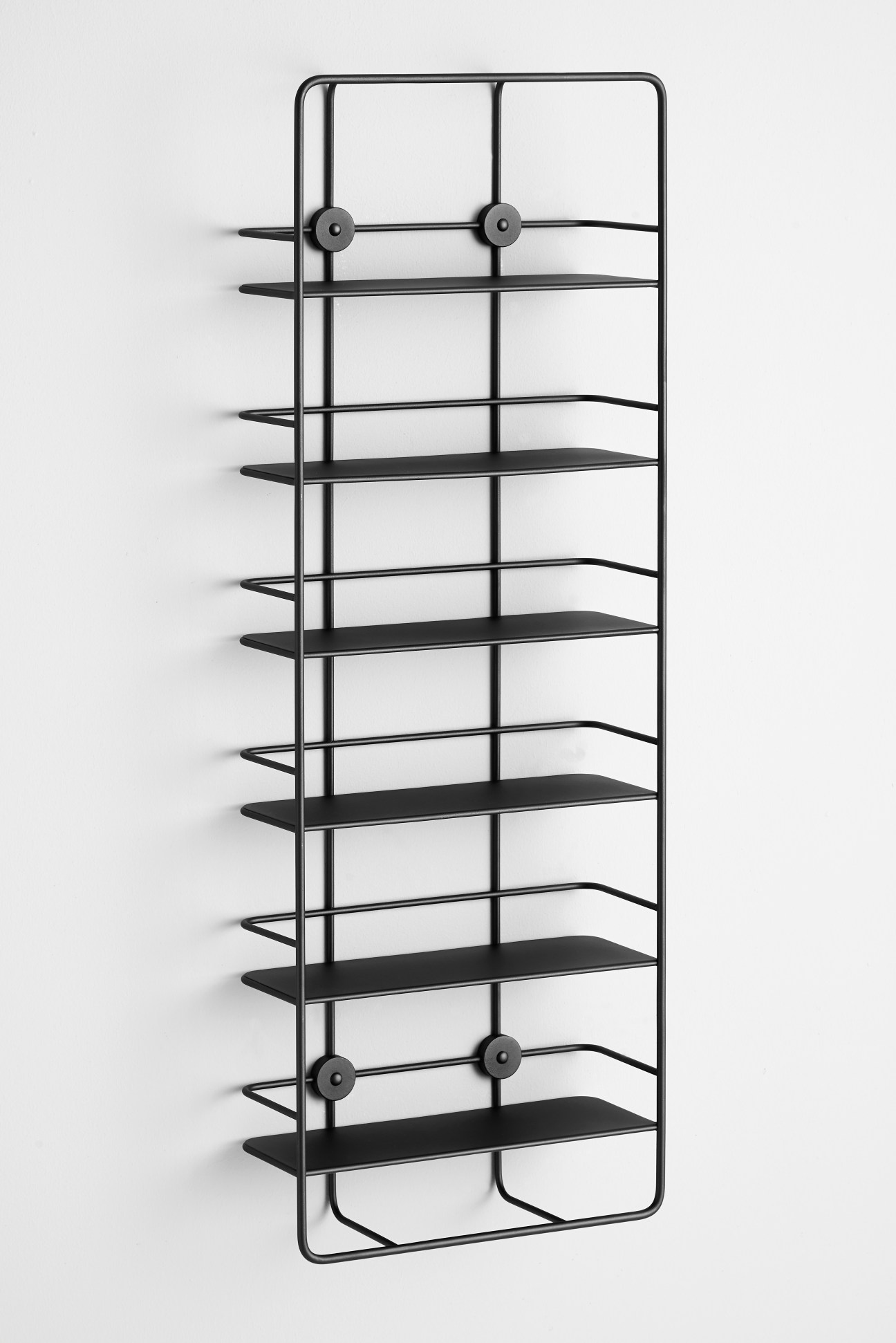 Coupé shelving unit by Poiat for Woud featuring black metal frame with multiple horizontal shelves.