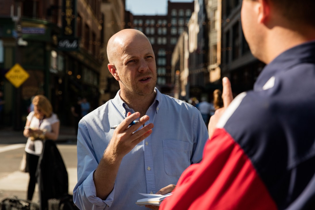 Martin Gelin, a Swedish correspondent, speaks with someone on a city street during election coverage.