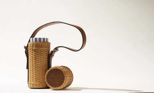 Wicker wine tote with striped linen lining and leather handles by Ralph Lauren.