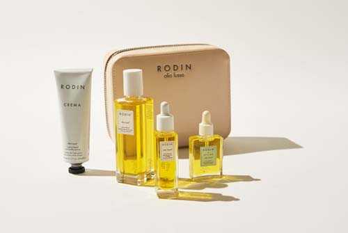 Rodin beauty travel kit with golden oil bottles and gray cream tube in tan branded box.
